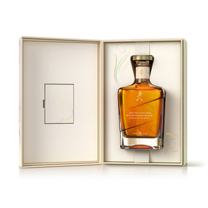 A bottle of John Walker & Sons Bicentenary Blend - 28 Year Old whisky in opened box against white background