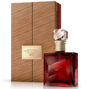 Three-quarter view of a bottle of Johnnie Walker Master's Ruby Reserve 40 Year Old whisky with box against white background