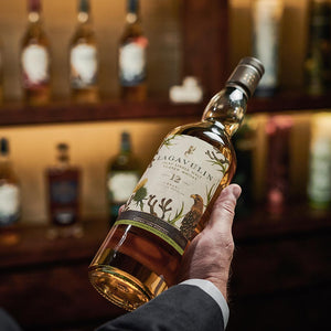 A bottle of Lagavulin 12 Year Old Special Release 2019, Islay Single Malt Scotch Whisky held in hand