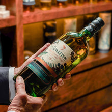 Load image into Gallery viewer, A hand holding a bottle of  The Singleton of Glen Ord 18 Year Old Special Release 2019  Single Malt Scotch Whisky
