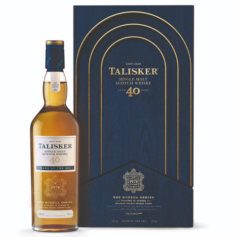 A bottle of Talisker Bodega 40 Year Old, Single Malt Scotch Whisky with box against white background